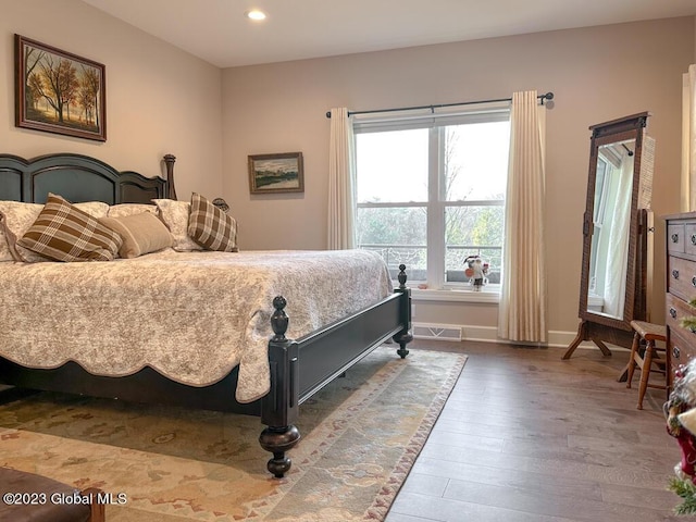 bedroom featuring recessed lighting, visible vents, baseboards, and wood finished floors