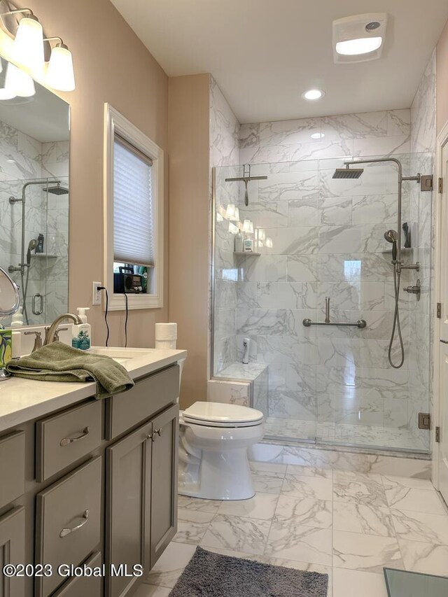 bathroom featuring a shower with door, tile patterned floors, toilet, and vanity