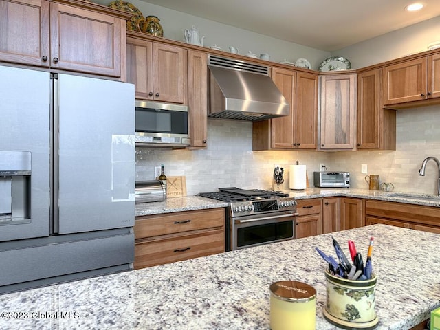 kitchen with a toaster, a sink, extractor fan, stainless steel appliances, and backsplash