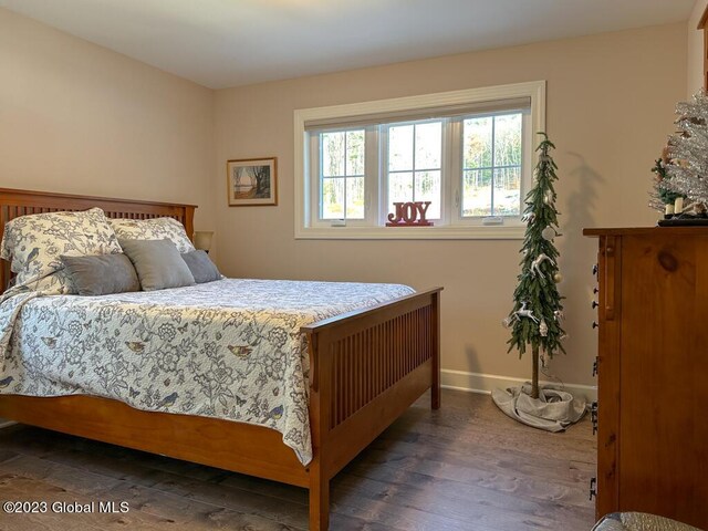 bedroom with dark wood-type flooring