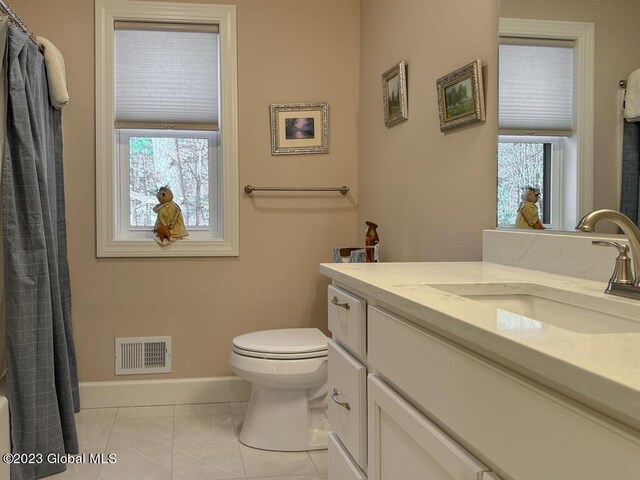 bathroom featuring tile patterned floors, toilet, and vanity