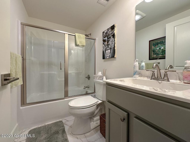 full bathroom featuring marble finish floor, bath / shower combo with glass door, visible vents, toilet, and vanity