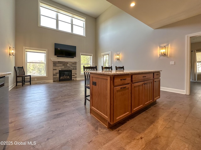 9 Hill Crest Ln Unit 3, Lake George, NY 12845 - kitchen with baseboards, a fireplace, and a healthy amount of sunlight