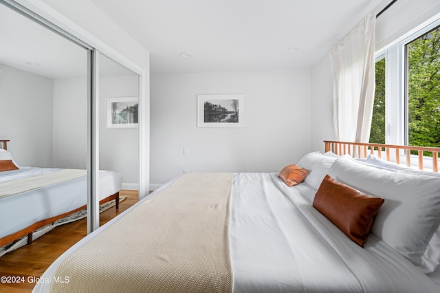 bedroom with a closet and hardwood / wood-style flooring