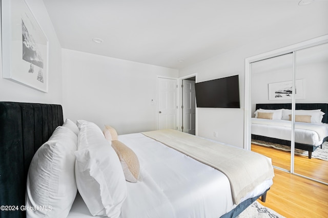 bedroom with hardwood / wood-style flooring and a closet