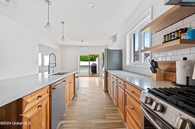 kitchen with pendant lighting, tasteful backsplash, sink, and stainless steel appliances