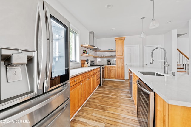 kitchen with pendant lighting, backsplash, sink, wine cooler, and stainless steel appliances