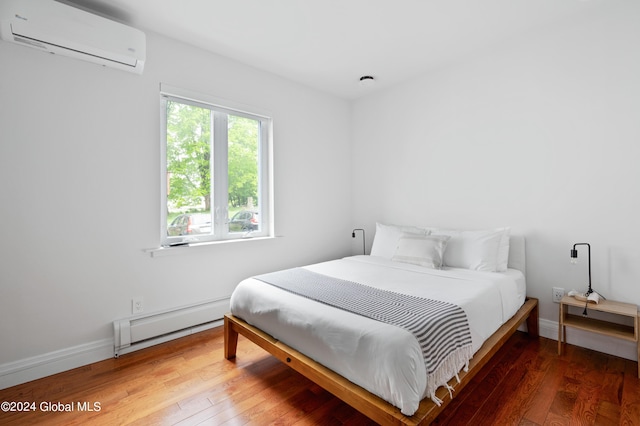 bedroom featuring hardwood / wood-style floors, an AC wall unit, and baseboard heating