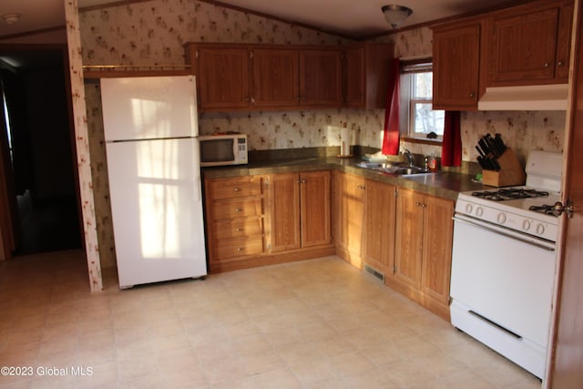 kitchen with sink and white appliances