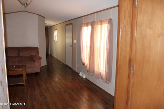 living room featuring crown molding and dark hardwood / wood-style flooring