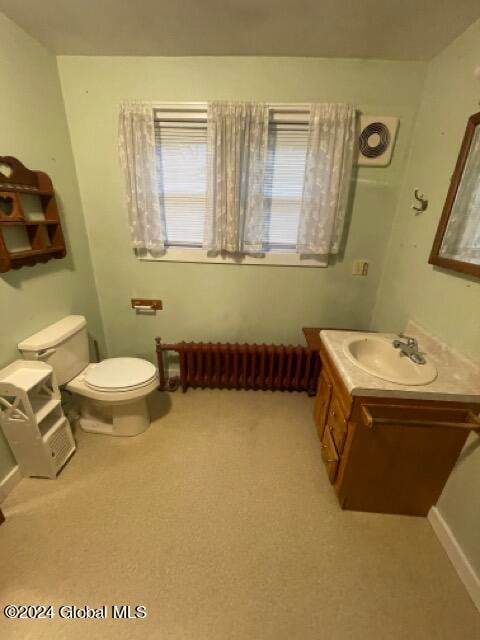 bathroom featuring oversized vanity and toilet