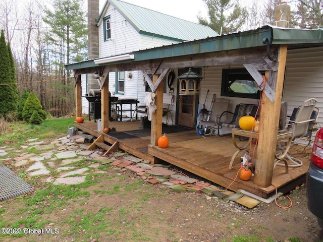 rear view of property featuring a deck