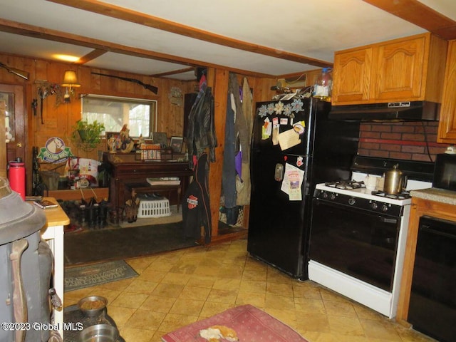 kitchen featuring wood walls and black appliances