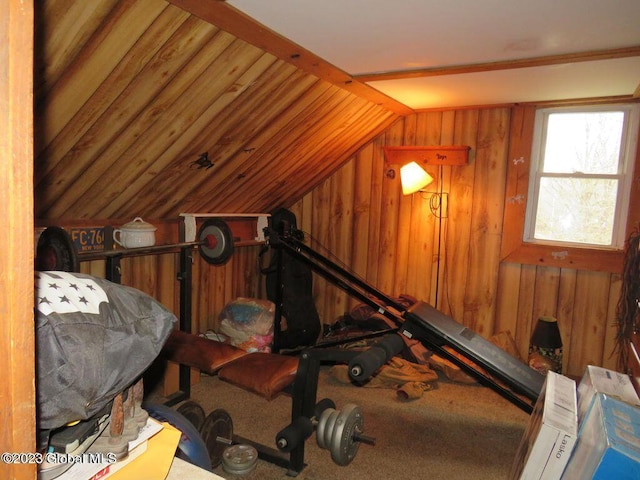 interior space featuring carpet floors, lofted ceiling, and wood walls