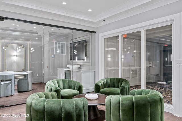 living area featuring recessed lighting, wood finished floors, and crown molding