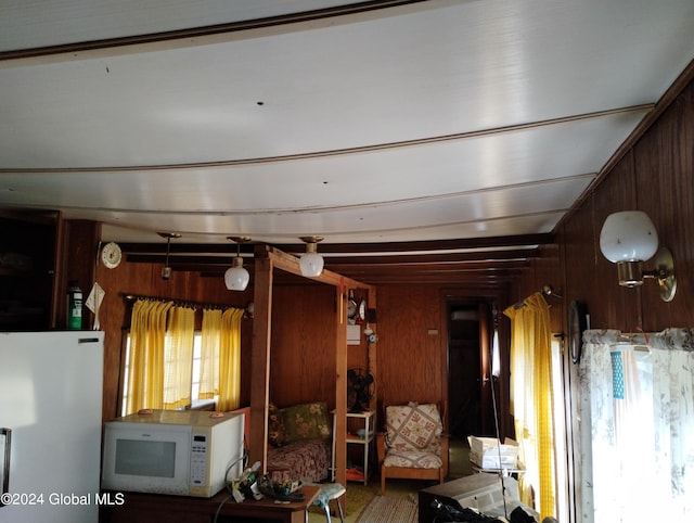 unfurnished living room featuring wooden walls