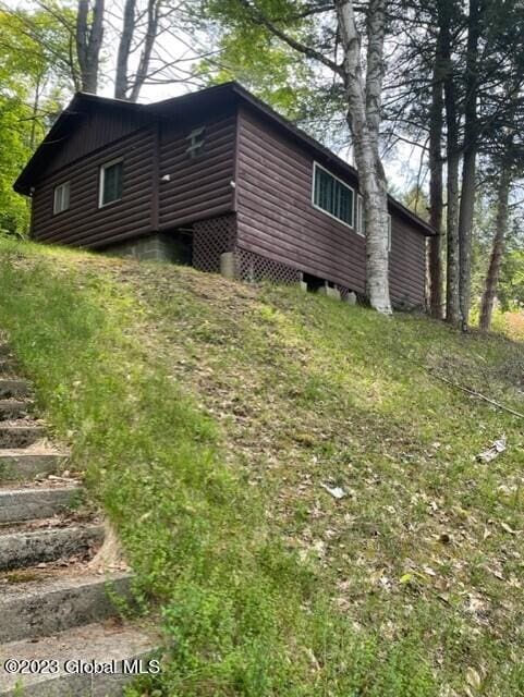 view of property exterior with log veneer siding