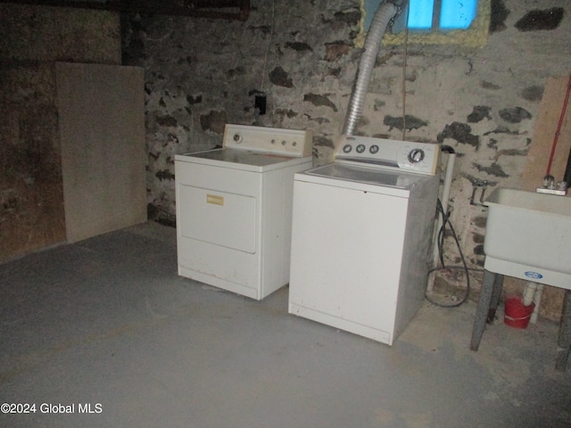 clothes washing area with sink and washer and dryer