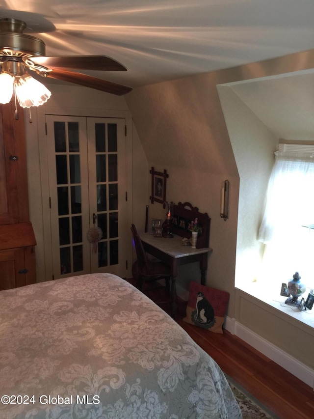 bedroom featuring a closet, dark hardwood / wood-style floors, ceiling fan, vaulted ceiling, and french doors