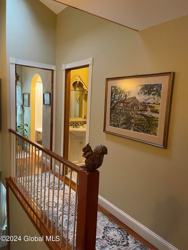 hallway featuring sink and wood-type flooring