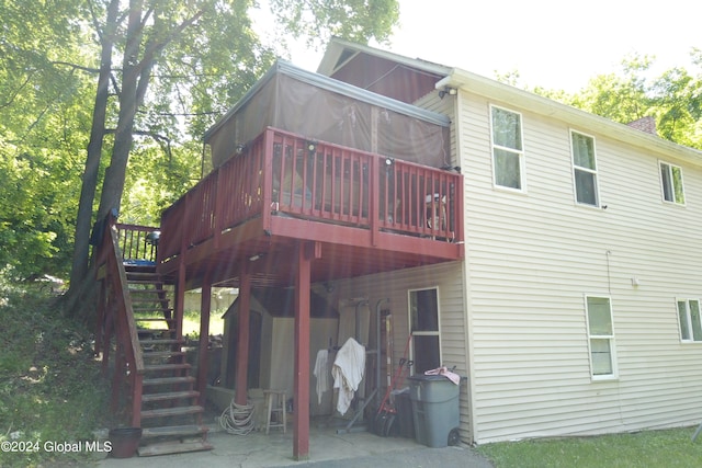 rear view of house with a deck and a patio area