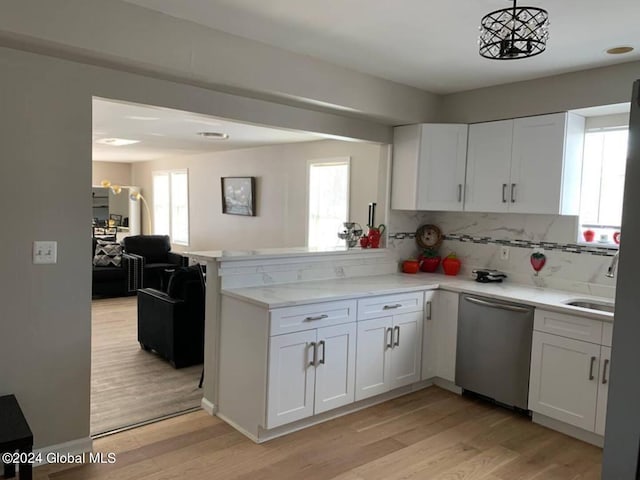 kitchen featuring white cabinets, light hardwood / wood-style flooring, dishwasher, and a wealth of natural light