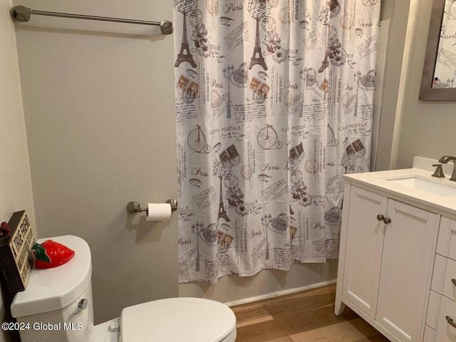 bathroom featuring hardwood / wood-style floors, toilet, and vanity