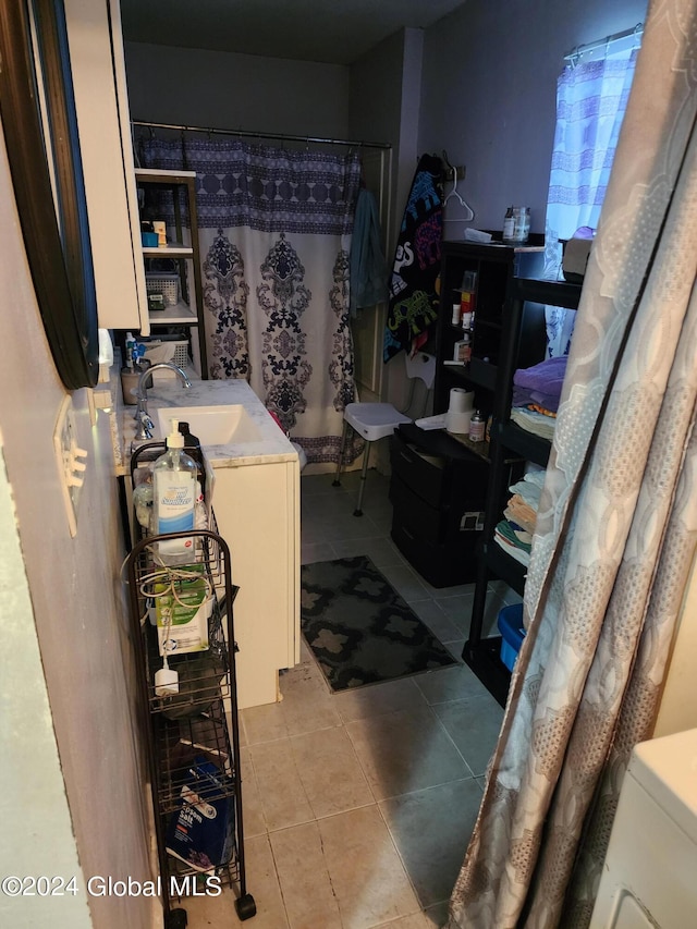 bathroom with tile floors and vanity