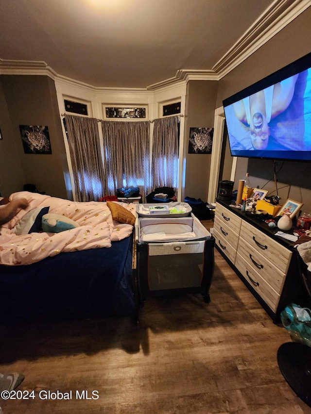 bedroom with crown molding and dark wood-type flooring