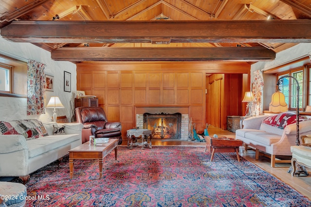 living room with wooden ceiling, lofted ceiling with beams, and a fireplace