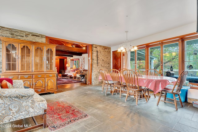 tiled dining room featuring a chandelier