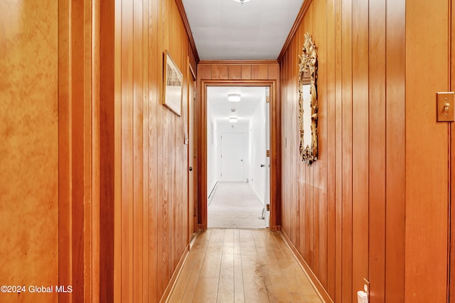 corridor featuring wood walls and light wood-type flooring