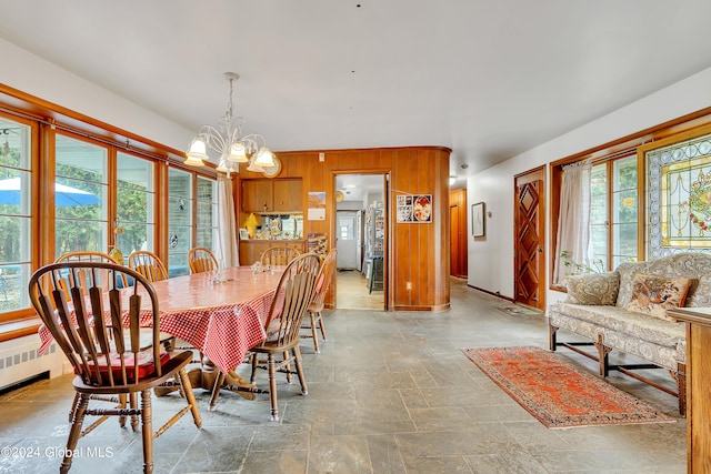 tiled dining space featuring a notable chandelier