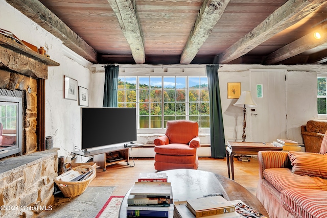 living room with a healthy amount of sunlight, wooden ceiling, wood-type flooring, and beam ceiling