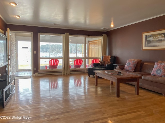 living room with ornamental molding and light hardwood / wood-style floors