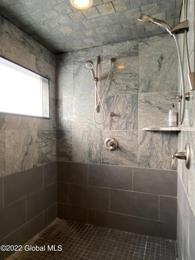 bathroom featuring a tile shower and tile patterned floors