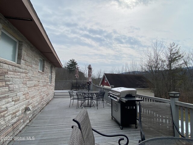 wooden terrace with a grill