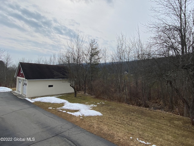 view of home's exterior with a yard and a garage