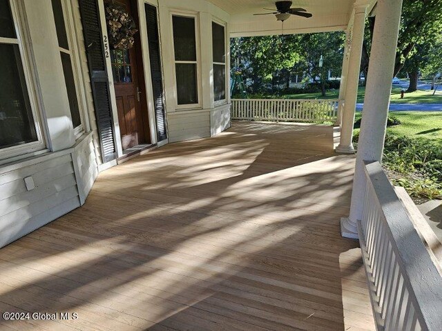 wooden deck featuring ceiling fan