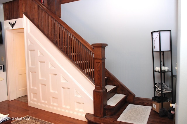stairway with dark wood-type flooring