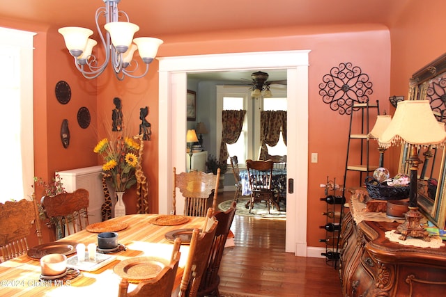 dining room featuring dark hardwood / wood-style floors and ceiling fan with notable chandelier