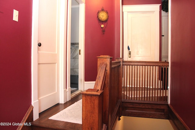 stairs with dark hardwood / wood-style floors