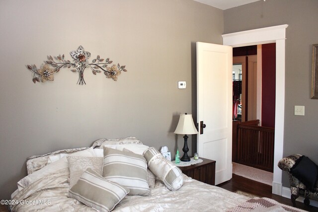 bedroom with dark hardwood / wood-style floors