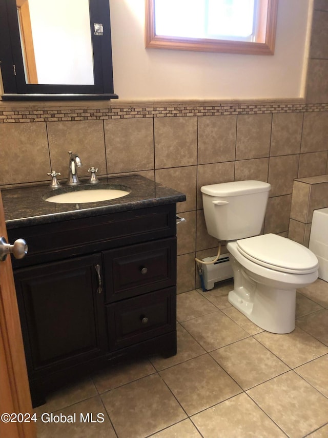 bathroom featuring tile walls, tile floors, tasteful backsplash, toilet, and vanity