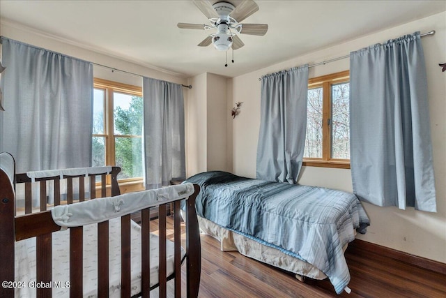 bedroom featuring dark hardwood / wood-style floors and ceiling fan