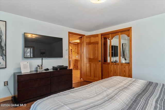 bedroom featuring a closet and dark hardwood / wood-style flooring