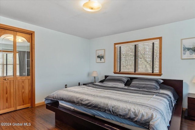 bedroom with dark hardwood / wood-style floors