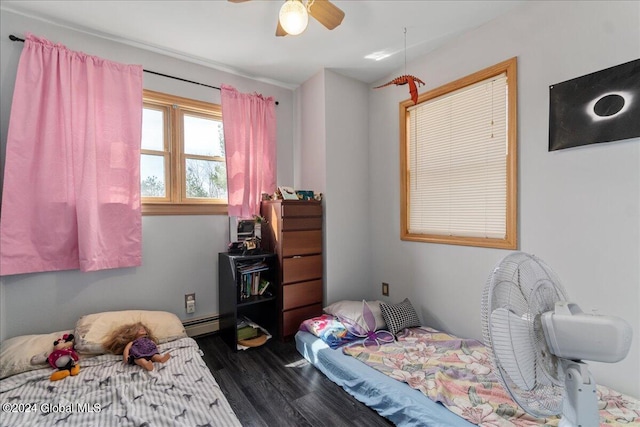 bedroom featuring ceiling fan, baseboard heating, and dark wood-type flooring