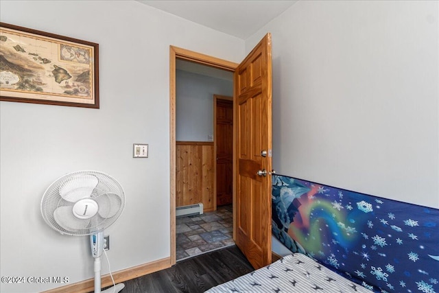 bedroom featuring dark hardwood / wood-style flooring and a baseboard heating unit