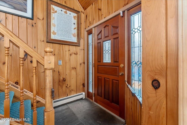 entryway with wood walls and a baseboard heating unit